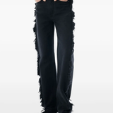 Black jean worn by a person, showing the jeans fit