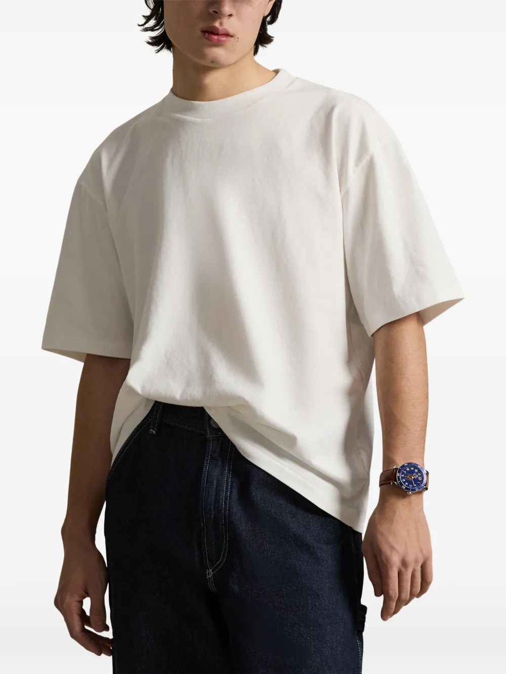 White t-shirt worn by a person, showing the t-shirt fit