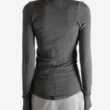 Grey t-shirt worn by a person, showing the shirt's fit