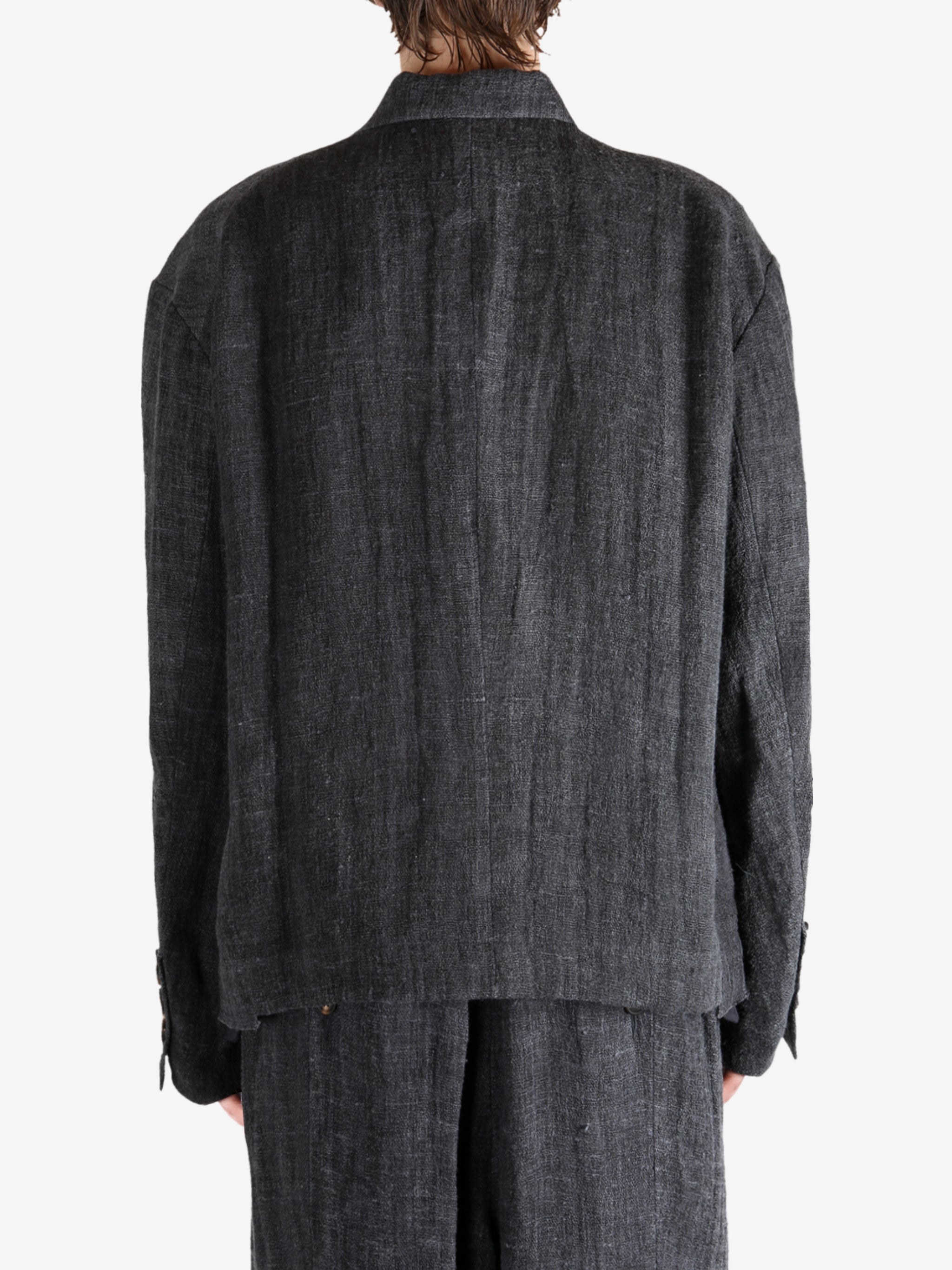 Black shirt worn by a person, showing the shirt's fit