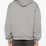 Grey hoodie worn by a person, showing the hoodie fit