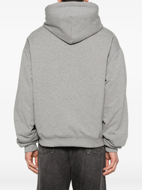 Grey hoodie worn by a person, showing the hoodie fit