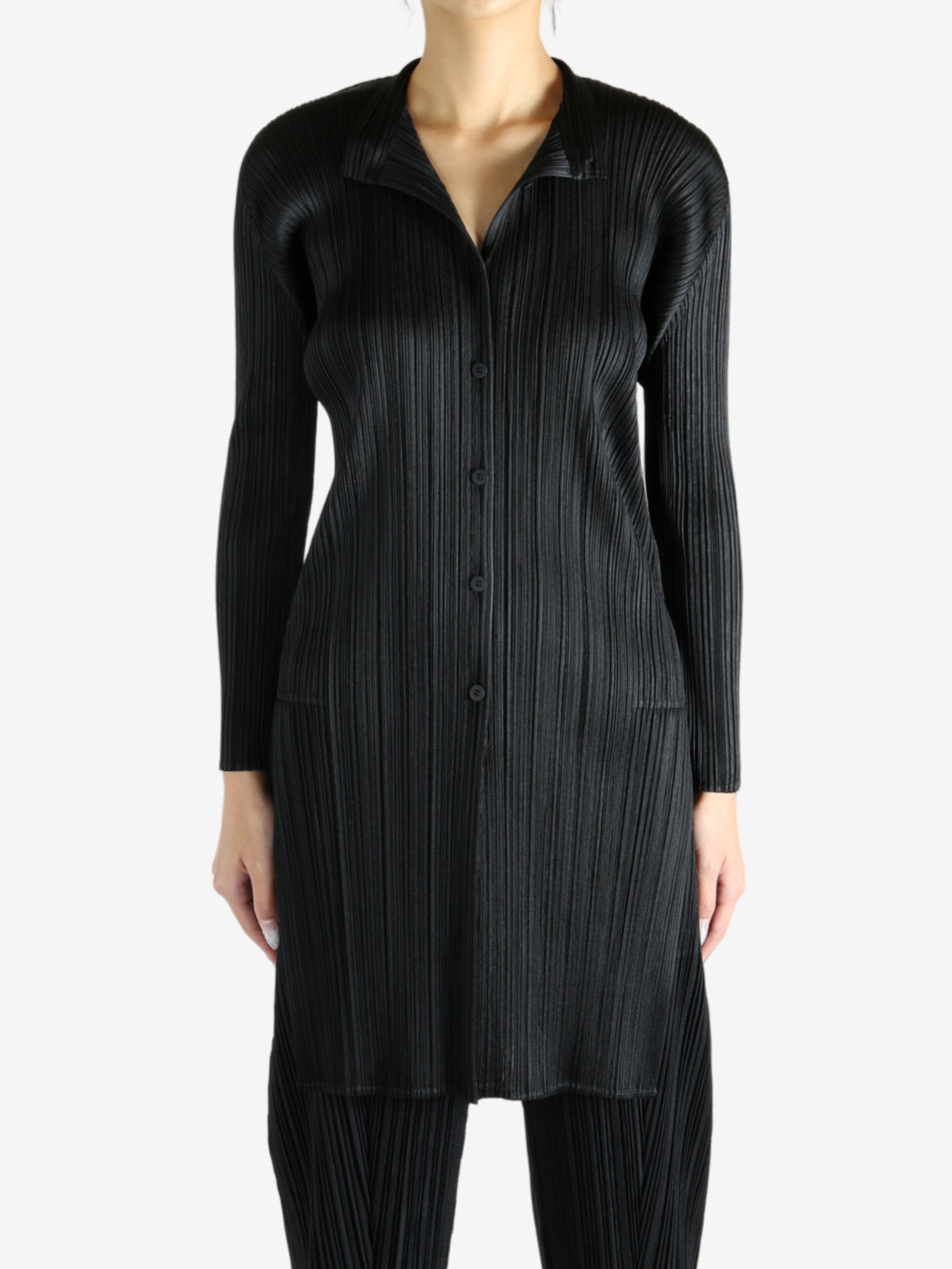 Black shirt worn by a person, showing the shirt's fit