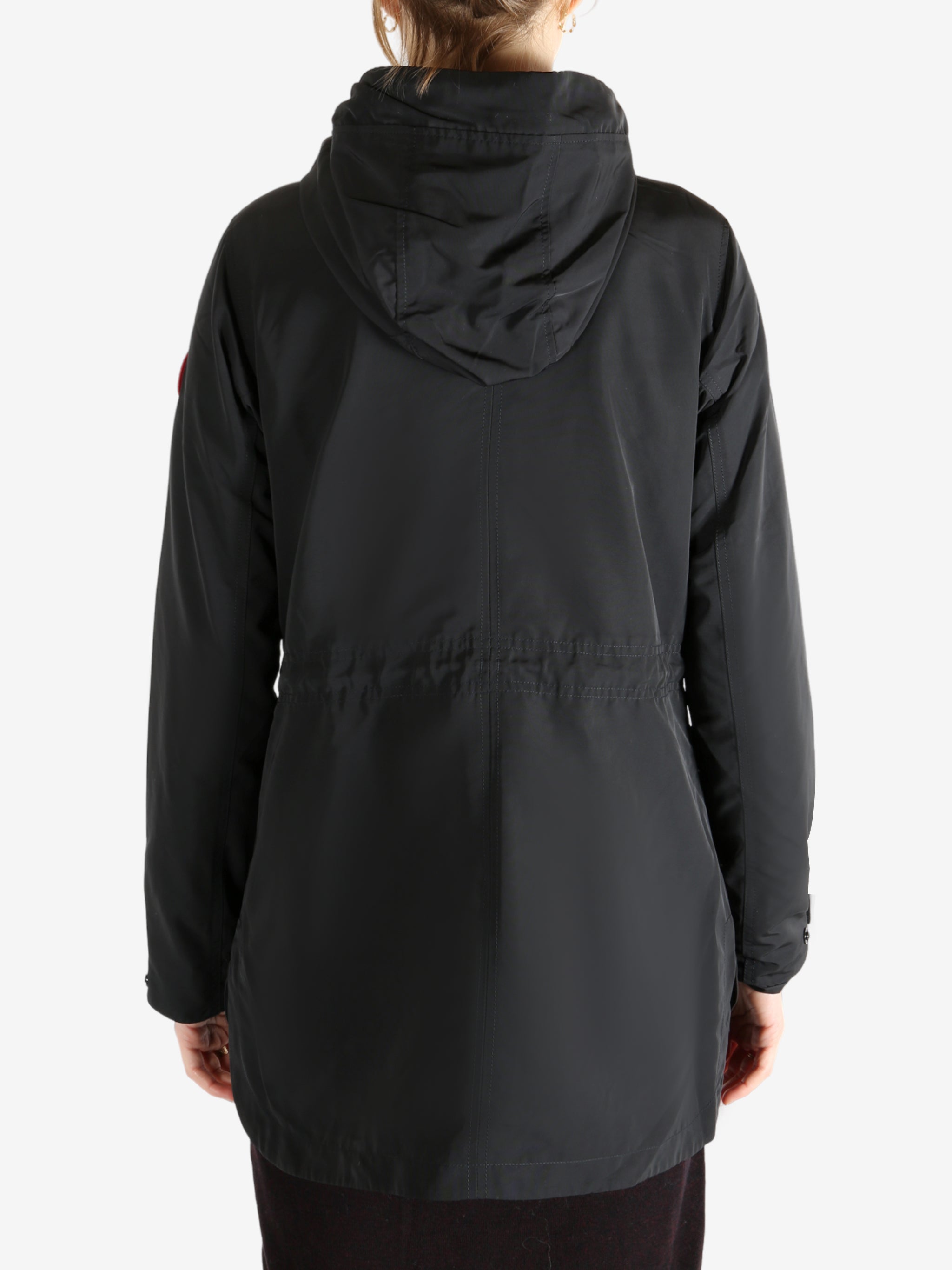 Black coat worn by a person, showing the coat fit