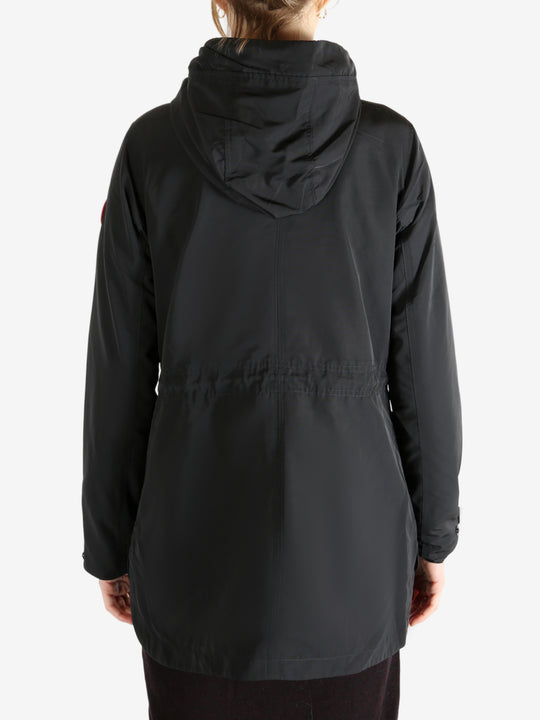 Black coat worn by a person, showing the coat fit