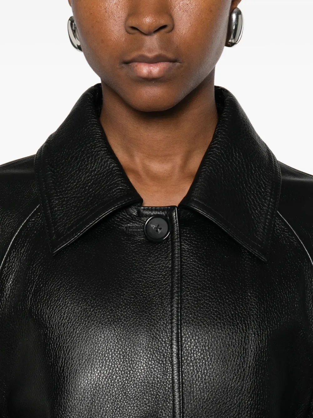 Close up of black coat,showing texture of the leather fabric