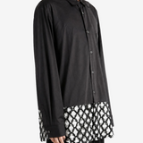 Black shirt worn by a person, showing the shirt fit