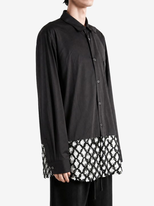 Black shirt worn by a person, showing the shirt fit