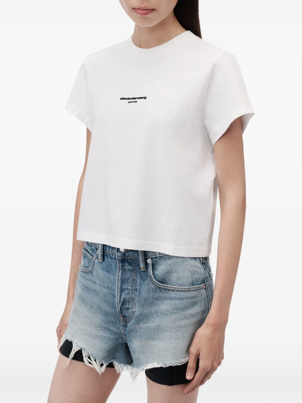 White t-shirt worn by a person, showing the t-shirt fit