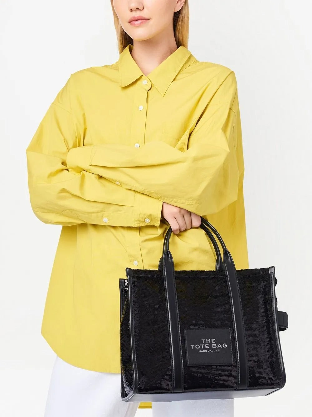 Black bag carried by a person, showing the bag's fit