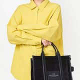 Black bag carried by a person, showing the bag's fit