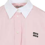 Close up of the pink shirt, showing texture of the cotton fabric