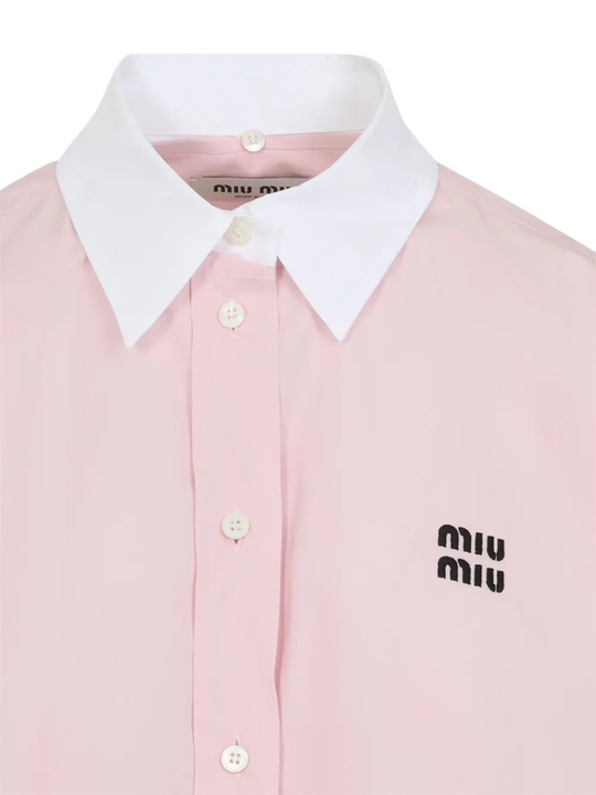 Close up of the pink shirt, showing texture of the cotton fabric