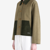 Green jacket worn by a person, showing the jacket fit