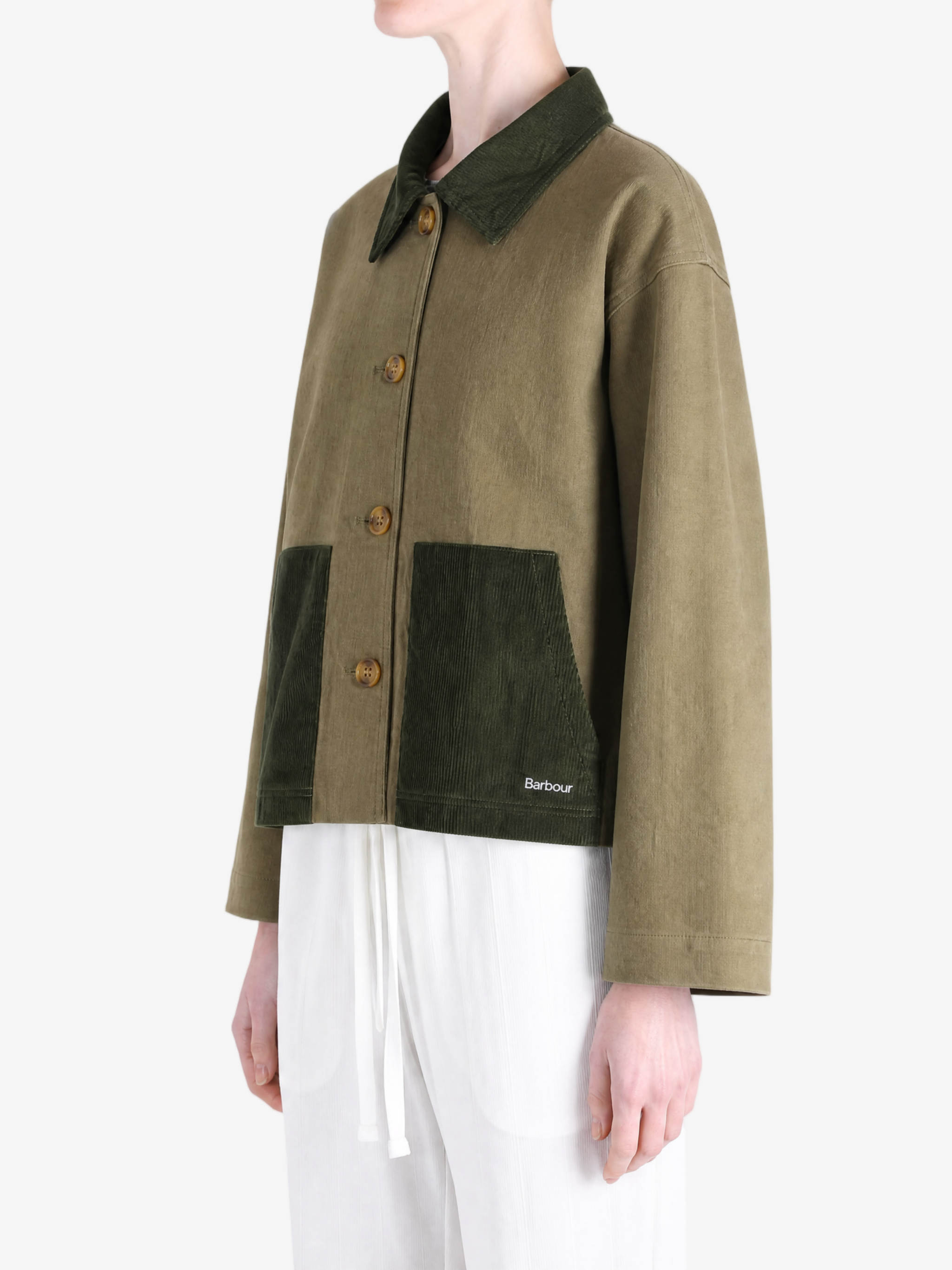 Green jacket worn by a person, showing the jacket fit
