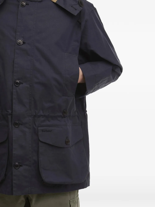 close up of blue jackets and coats, showing texture of the cotton  fabric
