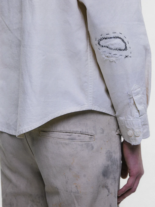 White shirt worn by a person, showing the shirt fit
