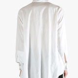 White shirt worn by a person, showing the shirt fit