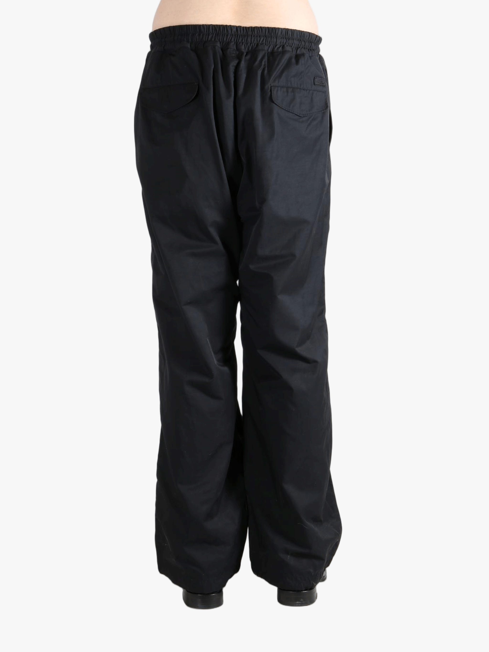 Black pants  worn by a person, showing the pants fit
