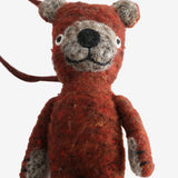 Close up of red doll, showing texture of the wool and cotton fabric
