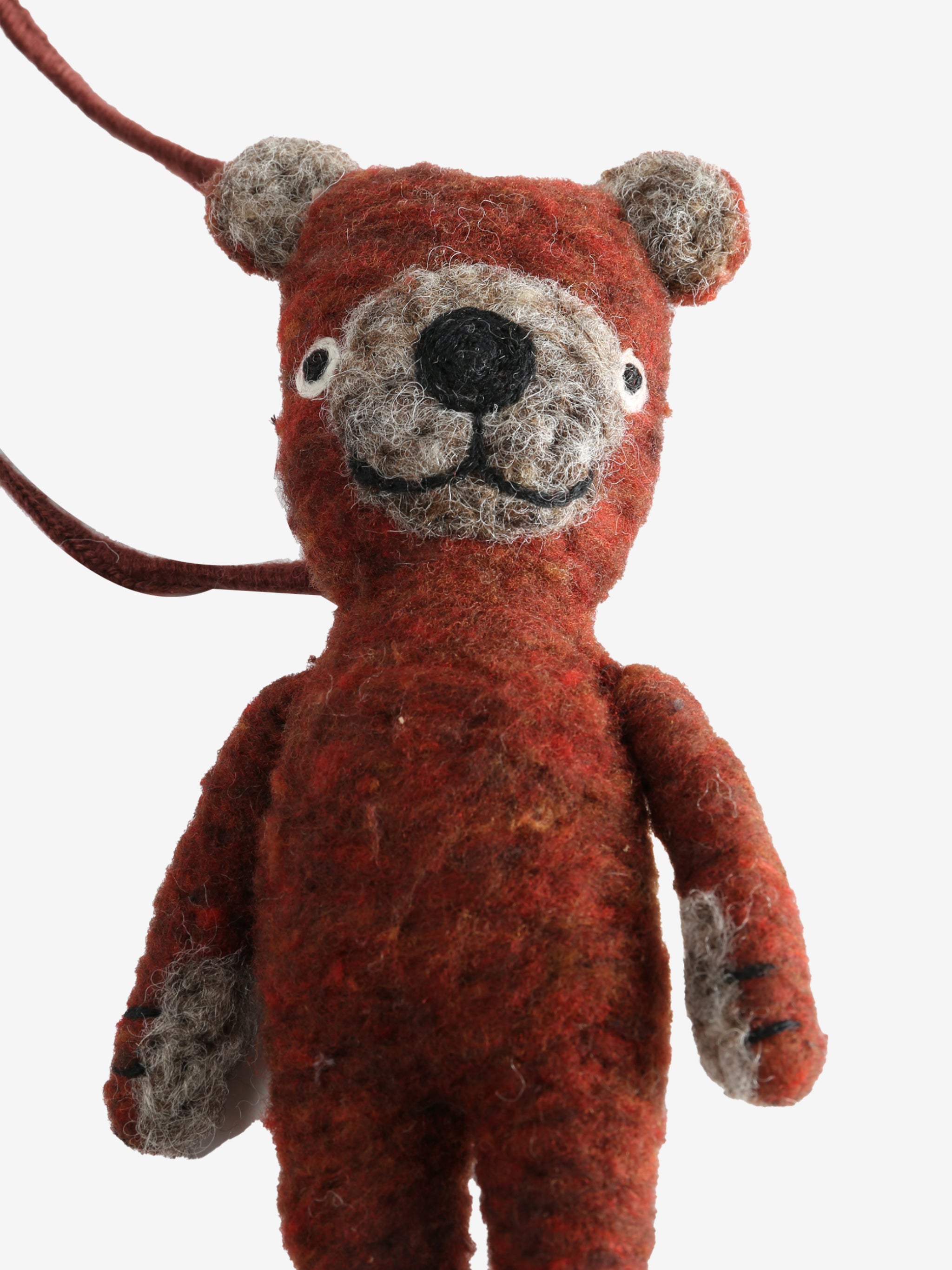 Close up of red doll, showing texture of the wool and cotton fabric