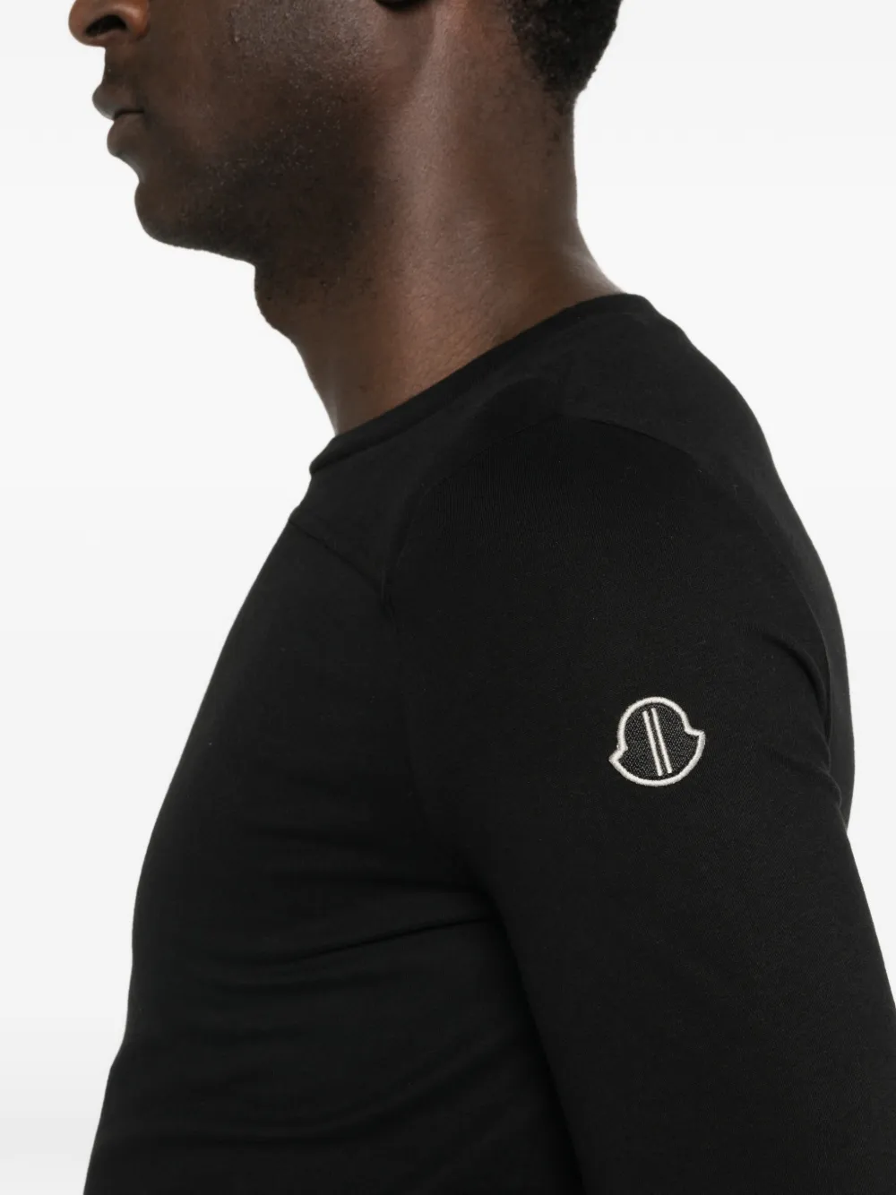 Close up of black shirt, showing the texture of cotton fabric