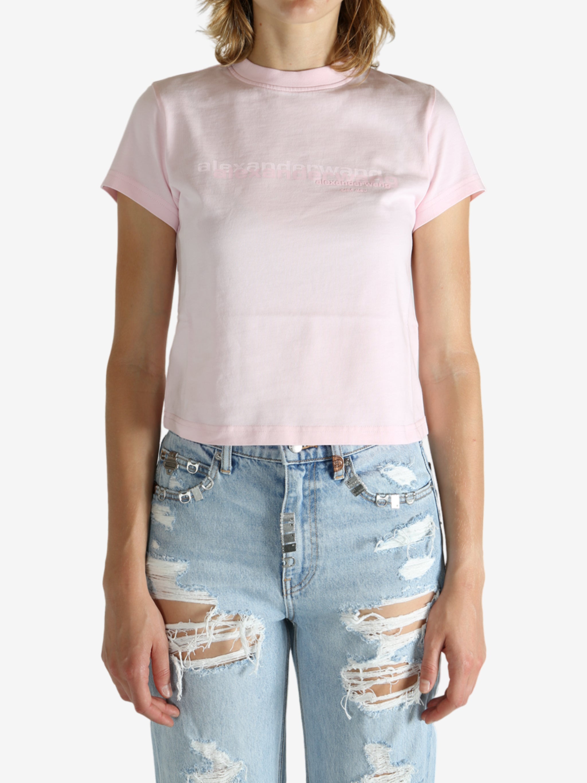 Pink t-shirt worn by a person, showing the shirt's fit