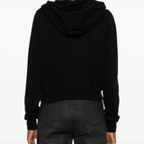 Black hoodie worn by a person, showing the hoodie's fit