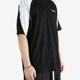 Black t-shirt worn by a person, showing the shirt's fit