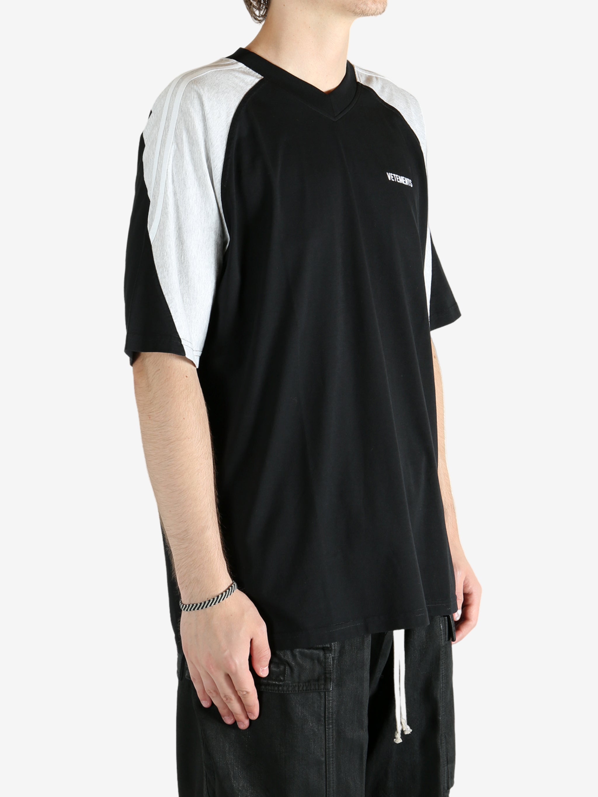 Black t-shirt worn by a person, showing the shirt's fit