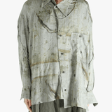 Green shirt worn by a person, showing the shirt's fit