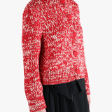 Red knitwear worn by a person, showing the knitwear fit