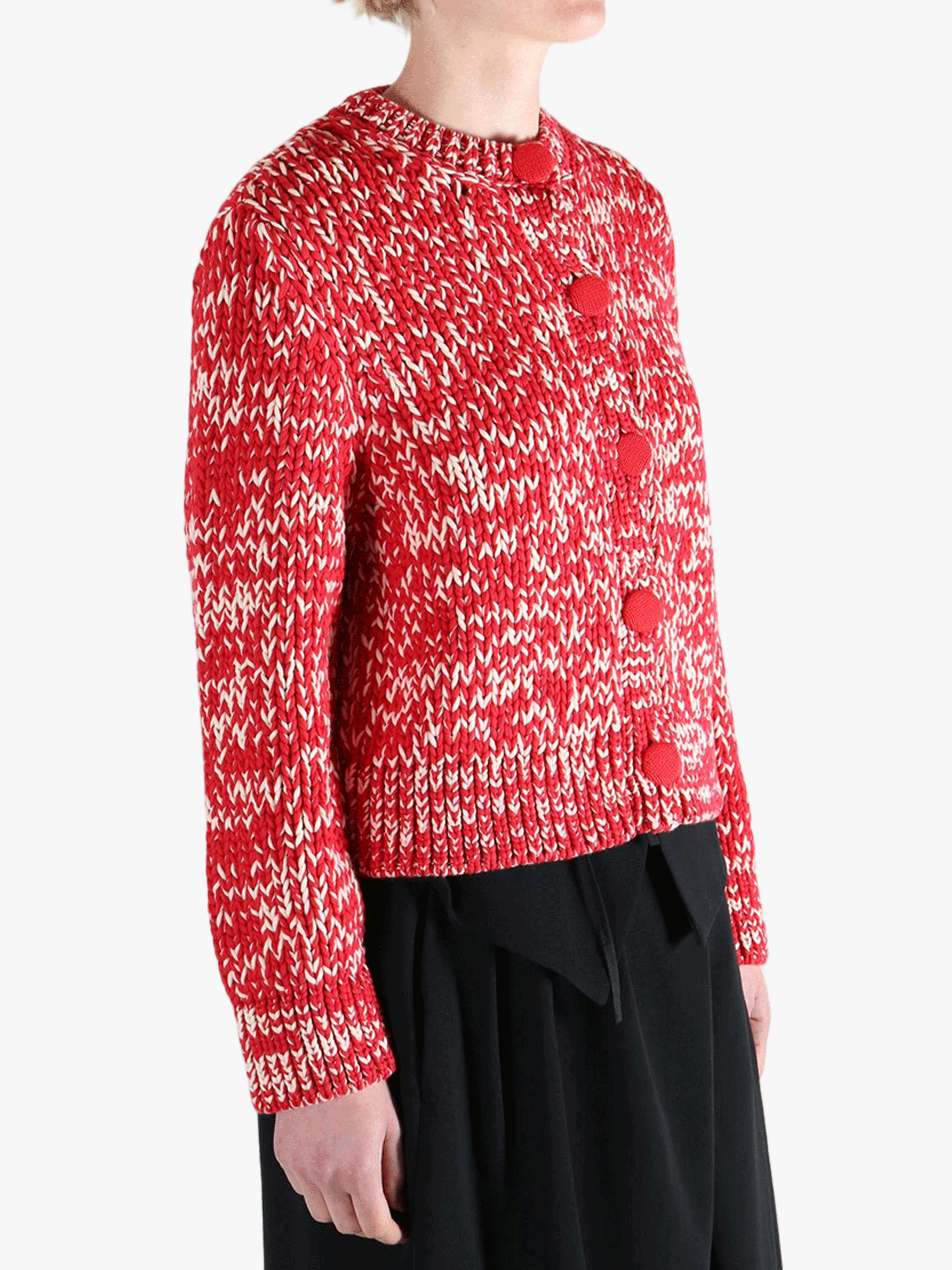 Red knitwear worn by a person, showing the knitwear fit