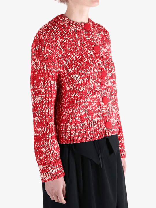 Red knitwear worn by a person, showing the knitwear fit