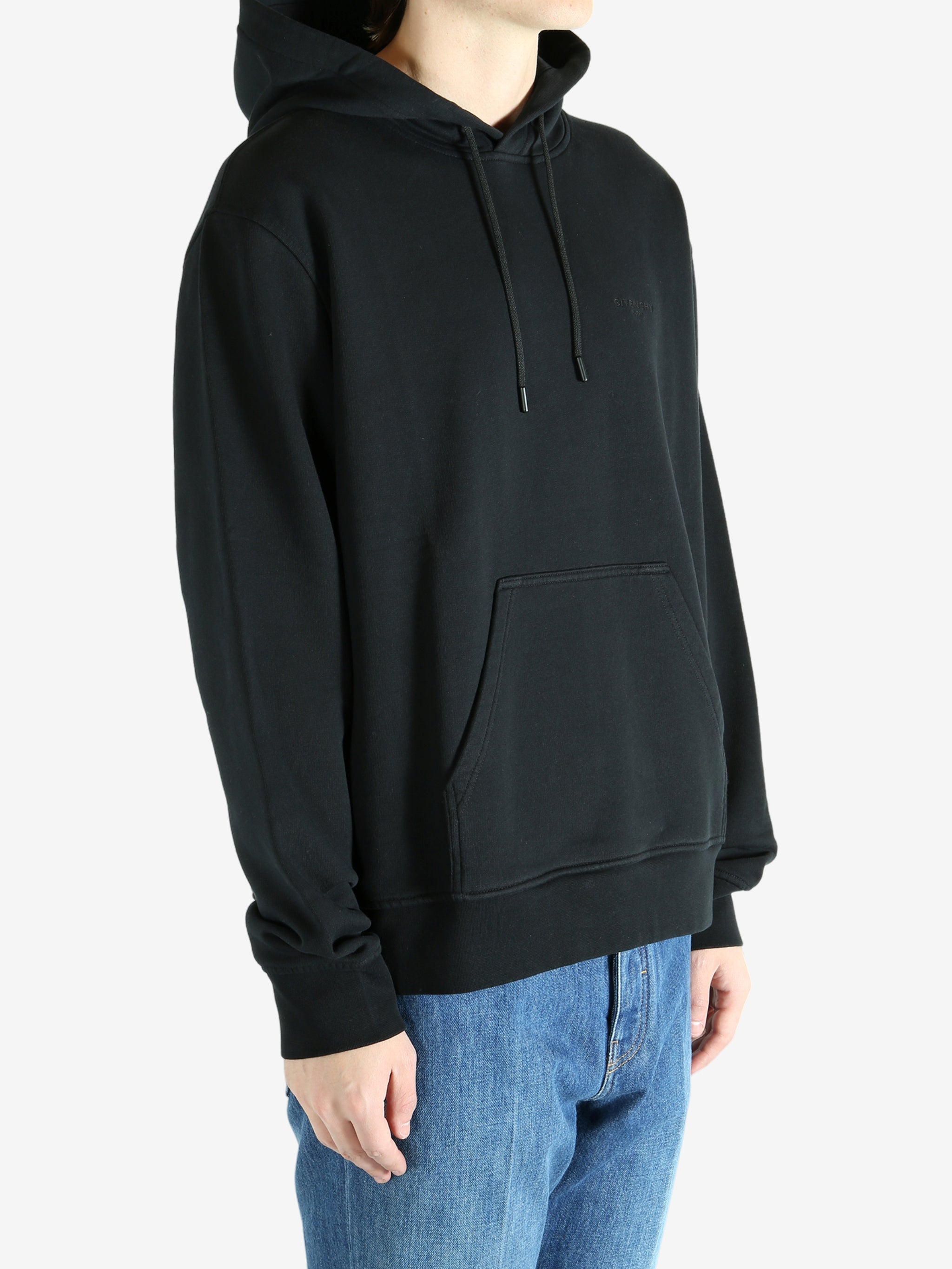 Black hoodie worn by a person, showing the hoodie's fit