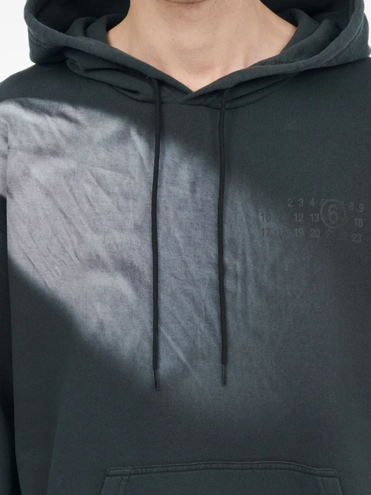 Close up of the black hoodie, showing texture of the cotton fabric