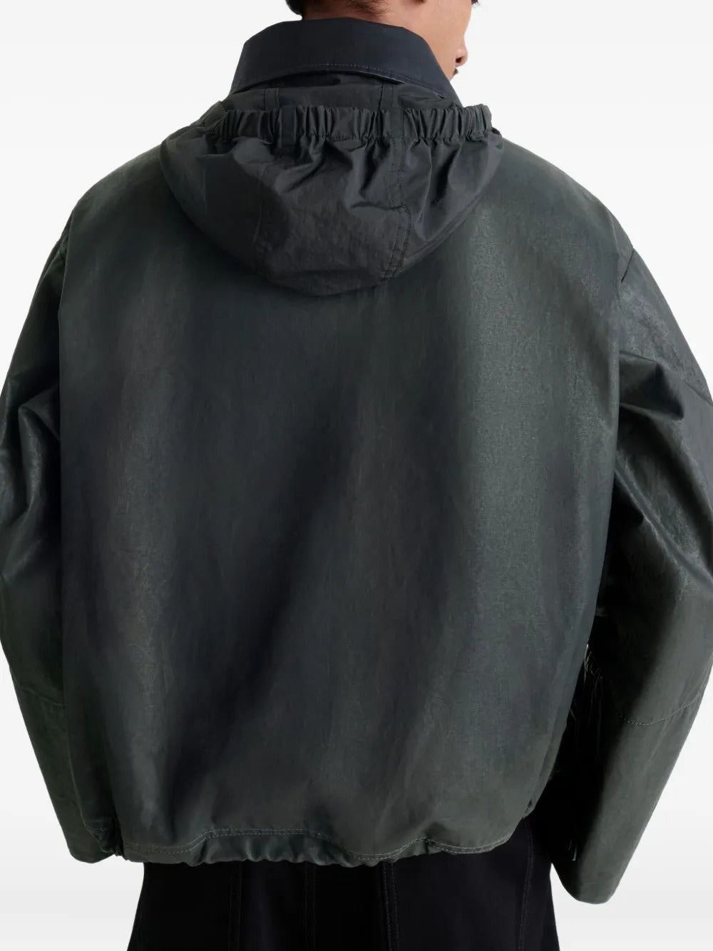 Black jacket worn by a person, showing the jacket's fit