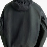 Black jacket worn by a person, showing the jacket's fit