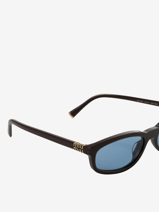 Close up of the brown pant, showing texture of the acetate fabric