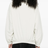 White jacket worn by a person, showing the jacket fit