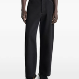 Black pants worn by a person, showing the pants fit