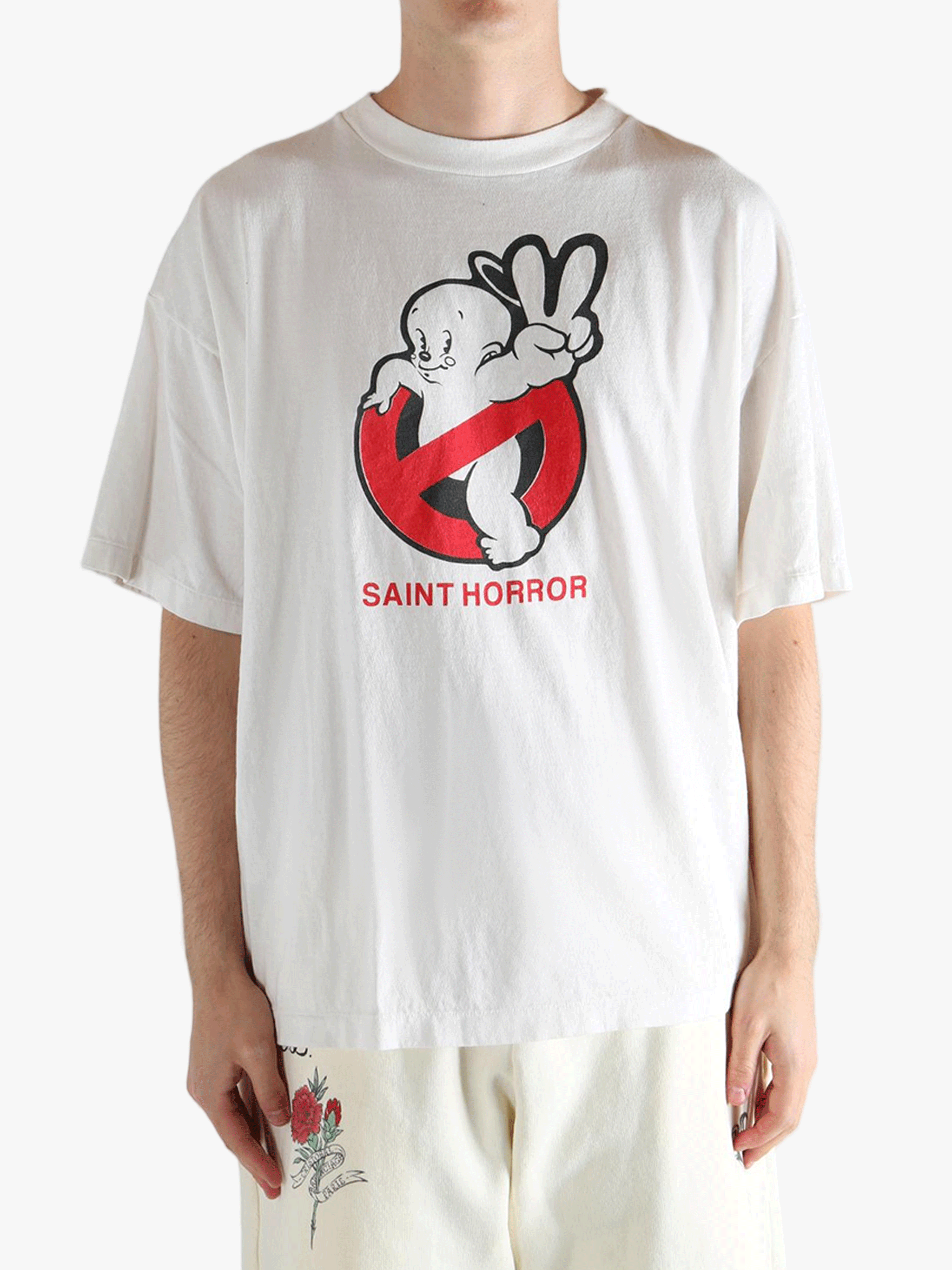 White t-shirt worn by a person, showing the shirt's fit