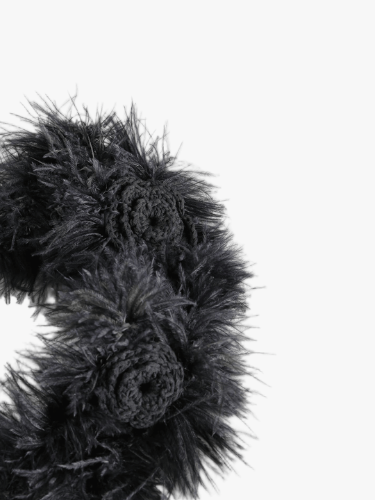 Close up of black headband, showing texture of the cotton fabric