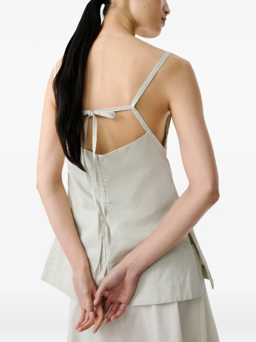 Grey tops worn by a person, showing the tops's fit