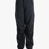 Black pants worn by a person, showing the pants fit