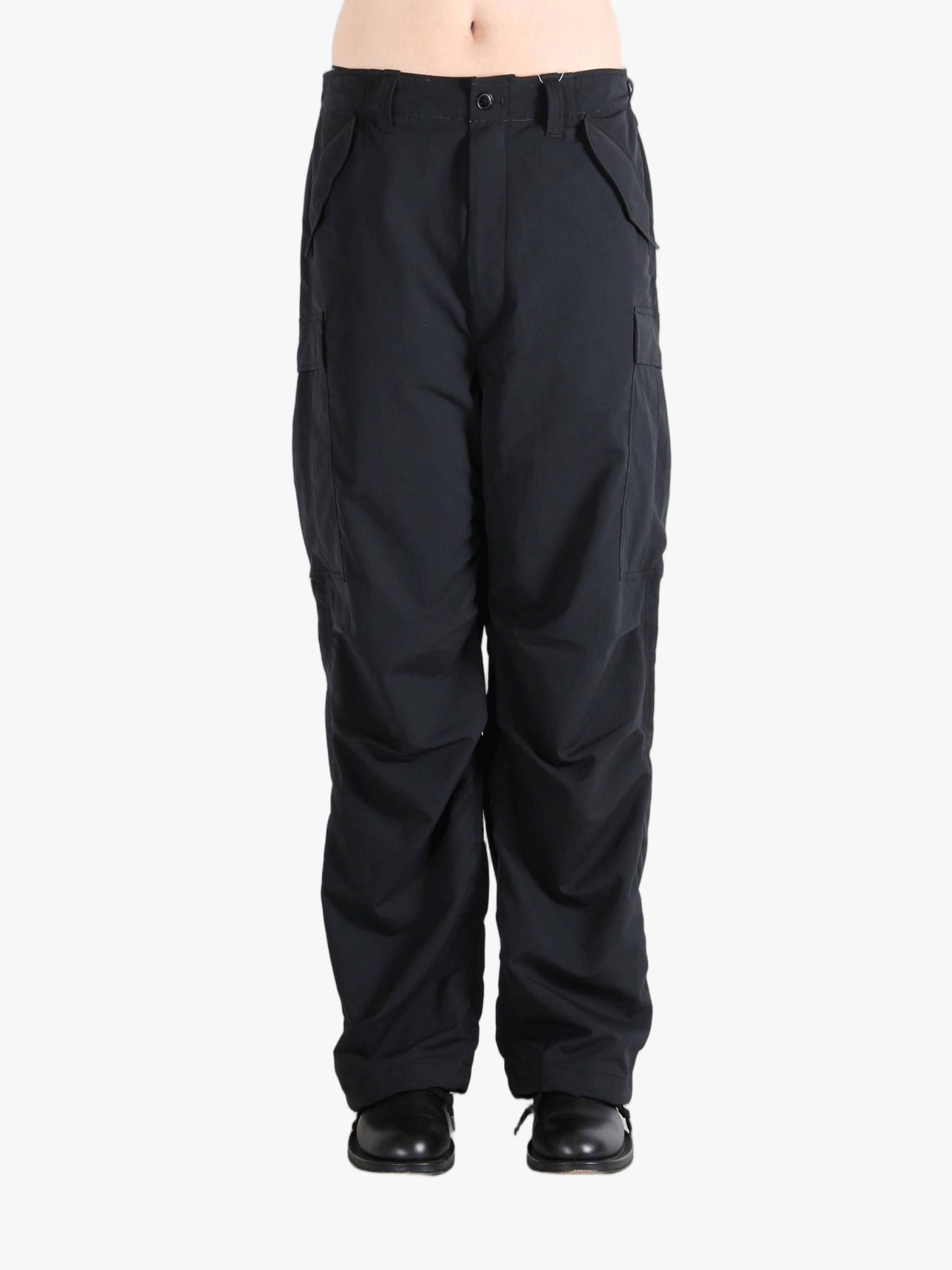 Black pants worn by a person, showing the pants fit