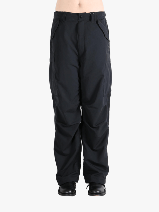 Black pants worn by a person, showing the pants fit