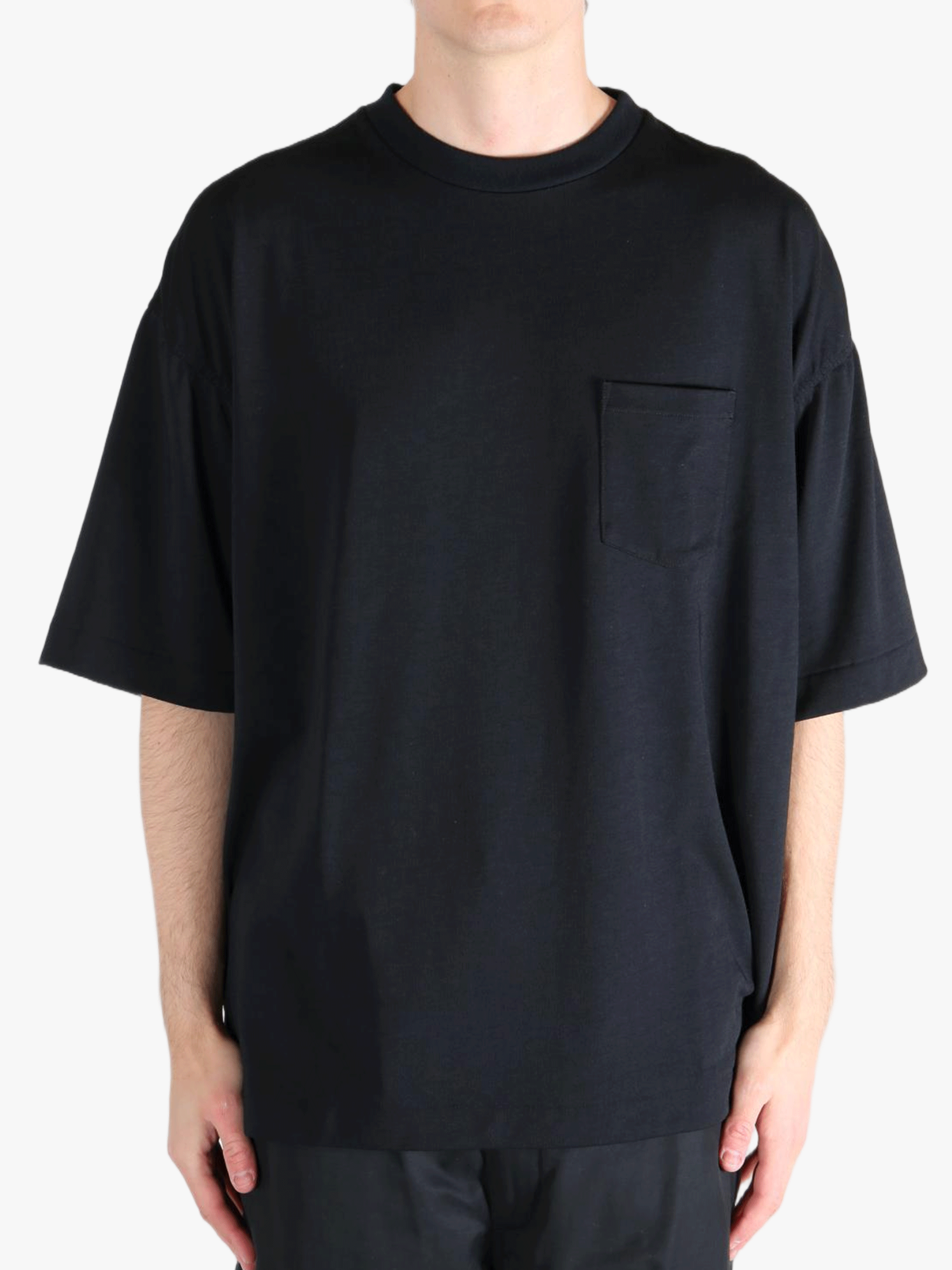 Black t-shirt worn by a person, showing the t-shirt's fit