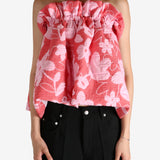 Red top worn by a person, showing the top fit