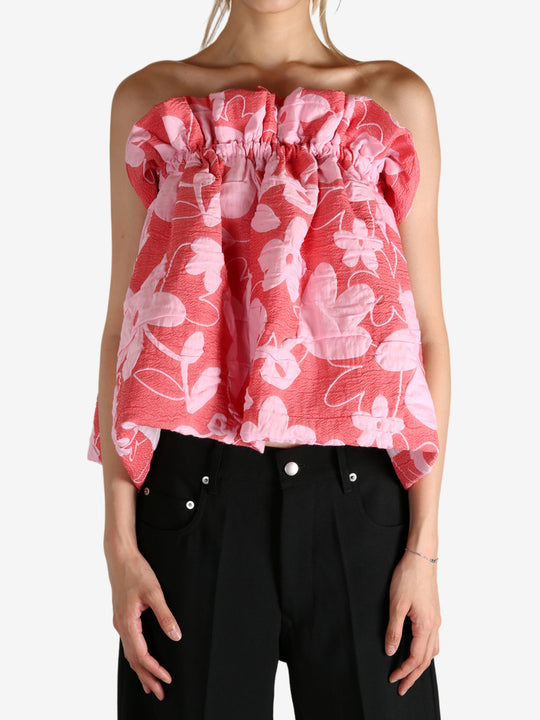 Red top worn by a person, showing the top fit